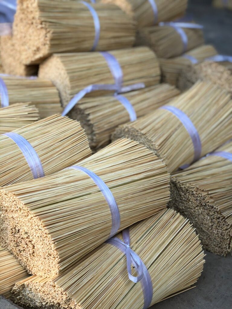 Close-up of tied bamboo incense stick bundles ready for packaging in India.